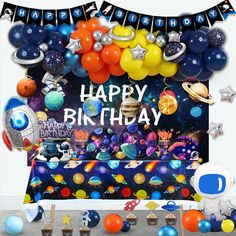 an image of a birthday party with balloons and space themed items on the table in front of it