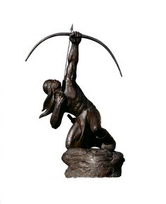 a bronze statue of a man holding an axusturine on top of a rock