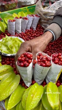 a person is picking berries from a tray