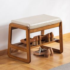 a wooden shoe rack with several pairs of shoes on it next to a pair of slippers