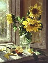 a vase filled with yellow sunflowers sitting on top of a window sill