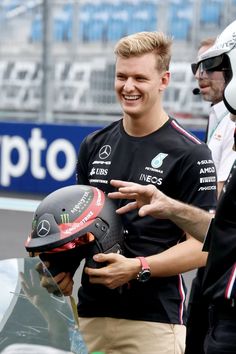 a man with a helmet talking to another man