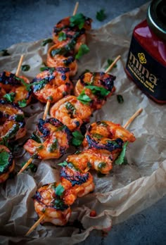 grilled shrimp skewers with cilantro and parsley garnish