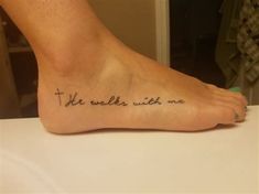 a person with a tattoo on their foot that says, the world's with me