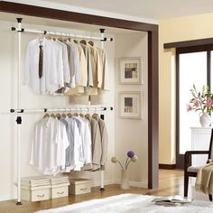 an open closet with clothes hanging on the wall