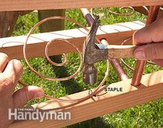 two hands are working on a piece of wood that is being made into a sculpture