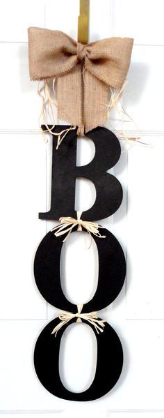 a wooden sign with the letter b on it and a burlock tied to it