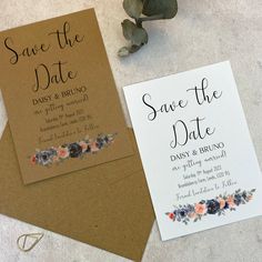 wedding save the date cards and envelopes with flowers on them next to a plant