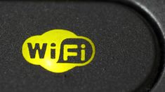 a close up view of a yellow and black button on a computer keyboard that says wifi