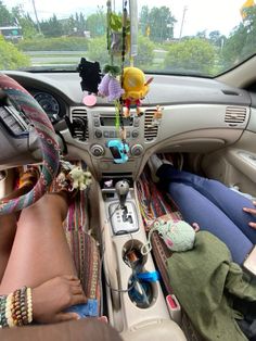 the interior of a car with stuffed animals and other items on it's dash board