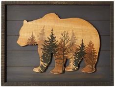 a wooden cutout of a bear in the woods