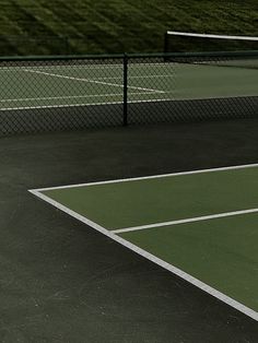 a man standing on top of a tennis court holding a racquet