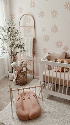 a baby's room with pink and white decor