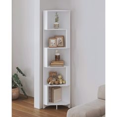 a living room with a couch, chair and book shelf in the corner next to a window