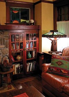 a living room filled with furniture and a fire place next to a lamp on a table