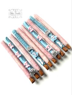 six blue and pink hair clips with bows on them are lined up in a row