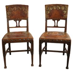 two wooden chairs sitting side by side