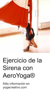 a woman is doing aerial yoga on a hammock in the middle of a room