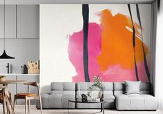 a living room filled with furniture and a large painting on the wall above it's couch