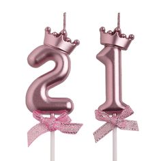 the number one cake topper is pink and has a bow on it