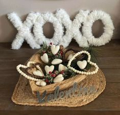 a basket filled with white hearts sitting on top of a wooden table next to the word boo