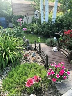 a wooden bridge surrounded by flowers and greenery