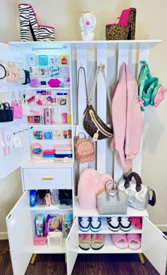 a white shelf filled with purses and handbags on top of wooden flooring