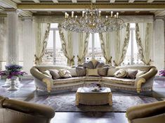 a fancy living room with chandelier and couches