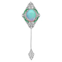 An unusual Art Deco inspired brooch set with a stunning 8.26 carat Ethiopian opal that displays vivid flashes of orange, green, and blue. Around the opal are crescents set with French cut Emerald and glittering diamonds that match so well and are very bright. This brooch is not just a piece of jewelry but a legacy of heritage. Brooch Information Style: Art Deco Metal: 18K White Gold Width: 25 mm. Length: 80 mm. Weight: 12.36 g. (approx. in total) Center Gemstones Type: Ethiopian Opal Shape: Oval Cabochon Size: 16.8 x 13.3 mm. Number: 1 Weight: 8.26 Carat (approx.) Accent Gemstones I Type: Emerald Shape: French Cut Size: 1.8 mm. Number: 28 Weight: 0.55 Carat (approx.) Accent Gemstones II Type: Diamond Shape: Round Average Color: H Average Clarity: SI Size: 1.3 - 2 mm. Number: 35 Weight: 0.5 Arm Art, French Cut, Unusual Art, Opal White, Art Deco Inspired, Diamond Shape, Emerald Diamond, Art Deco Style, Oval Cabochon