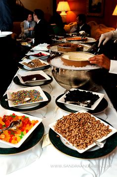 a buffet table filled with lots of different types of food and desserts on plates