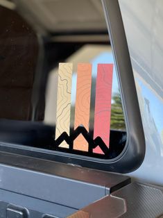 the side mirror of a car with colorful stickers on it