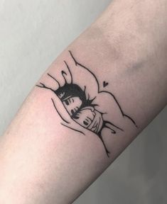 a person with a tattoo on their arm holding onto the arm of another person's arm