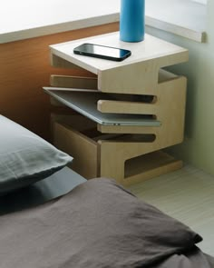 a nightstand with a phone on top of it