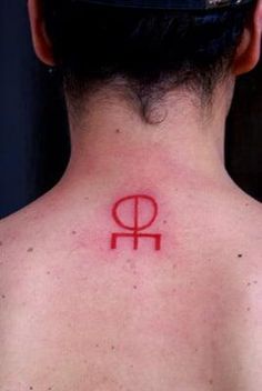 a man with a red tattoo on his back