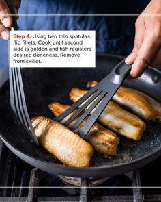 someone is frying fish in a skillet on the stove with a spatula