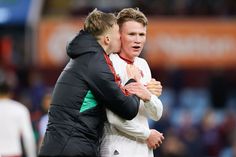 two soccer players embracing each other on the field