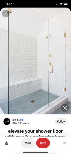 a bathroom with a walk in shower next to a white brick wall and flooring