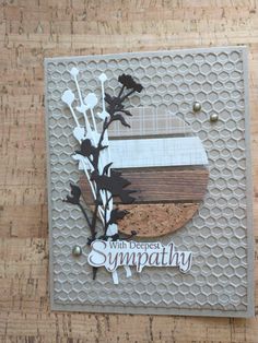 a close up of a piece of paper with flowers on it and the words sympathy written in white