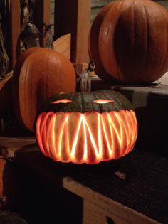 a carved pumpkin sitting on top of a wooden table