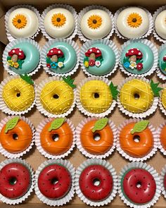 a box filled with lots of different colored donuts and doughnut holes on top of each other