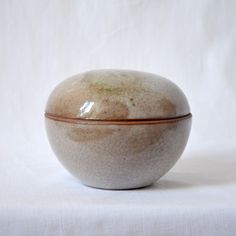 a white and brown bowl sitting on top of a table