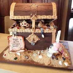 a cake made to look like an old trunk with pirate decorations on the top and bottom