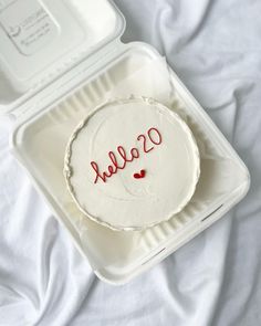 a white cake in a plastic container with the word sale written on it and red writing