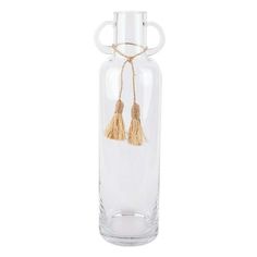 a clear glass vase with two tassels hanging from it's sides, on a white background