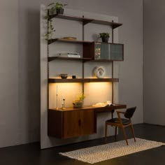 a room with a chair, desk and shelves on the wall next to a rug