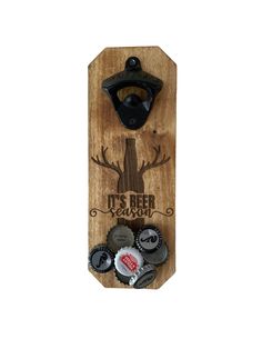 a bottle opener is mounted to a wooden plaque with buttons in the shape of a tree