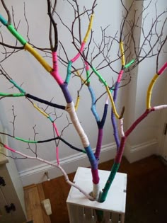 there is a tree that has been made out of colored sticks and paper machs