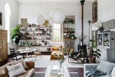 a living room filled with furniture and lots of plants