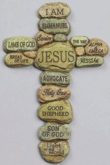 a cross made out of rocks with the words jesus written on it and in different languages