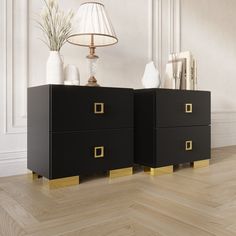 two black and gold nightstands on wooden floor next to lamp